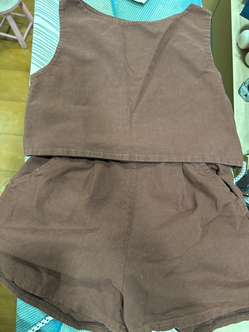 Brown Two-Piece Shorts Set (Category: Shorts) located in Quezon City. Submitted by struddels (Listing ID 1407854382, Image 1). Description: - Two-piece set includes a sleeveless top and shorts - Solid brown color - Shorts have pockets - Top features a scoop neckline - Made from a soft material - Ideal for casual wear.