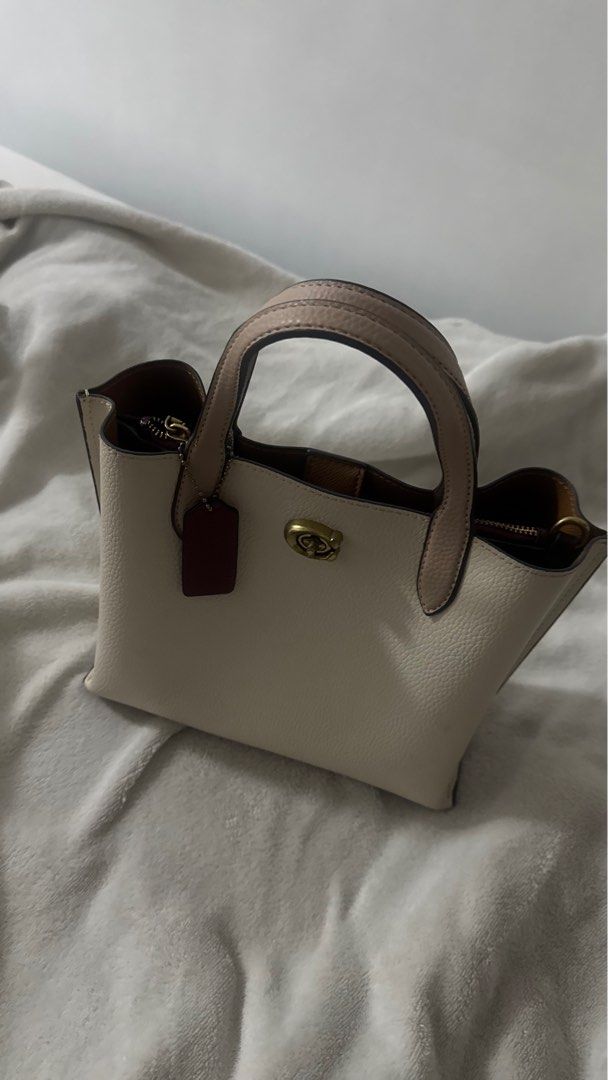Coach Small Town Tote Bag (Category: Luxury Bags & Wallets) located in Manila. Submitted by m.pasalubong (Listing ID 1407855337, Image 1). Description: - Coach Small Town Tote Bag - NGA (this was a gift) - Flaw ing last 2 pics - Cream exterior - Top handle - Detachable tag - Zip closure - Gold-tone hardware - Spacious interior - Dark burgundy interior lining.