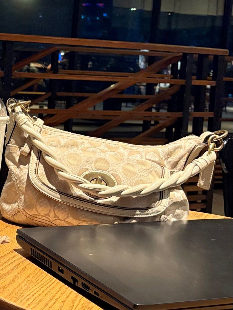 Coach Twisted 2-Way turn lock Bag (Category: Luxury Bags & Wallets) located in Makati City. Submitted by ayreen_ (Listing ID 1407866307, Image 2). Description: Coach twisted 2-way bag auth vintage condition: 7/10 dimension: approximately 7.5 x 11.5 inches strap: 21.5 inches folded (not adjustable) minimal rubs, fading on the leather part & hairlines sa hardware Authentic Coach twisted 2-way bag. Features a beige color with a signature pattern. In