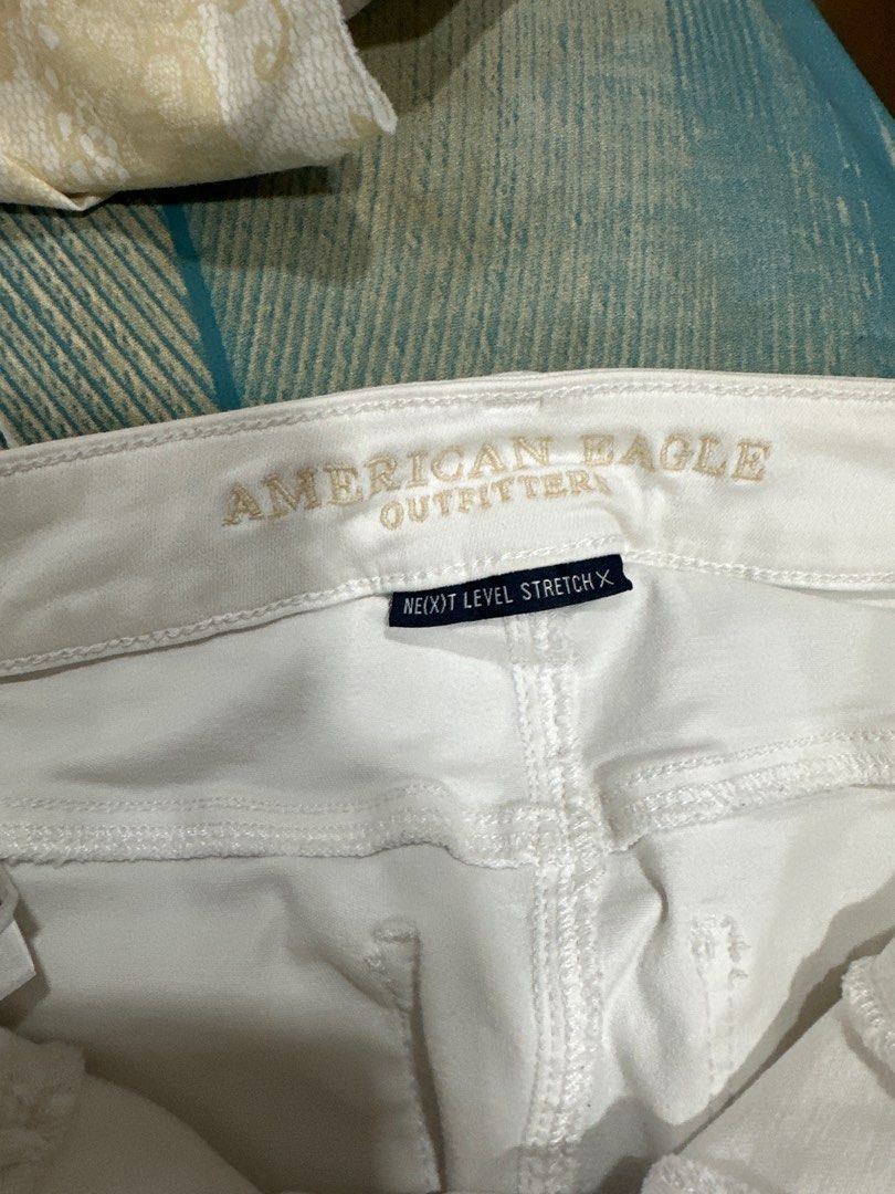 Distressed White Jeans (Category: Jeans) located in Quezon City. Submitted by struddels (Listing ID 1407892345, Image 2). Description: - American Eagle Outfitters white jeans - Distressed detailing - Next Level Stretch - Size 4, regular fit - Made in China - Fabric: 88% cotton, 9% polyester, 3% elastane - Classic five-pocket design - Zip fly with button closure.