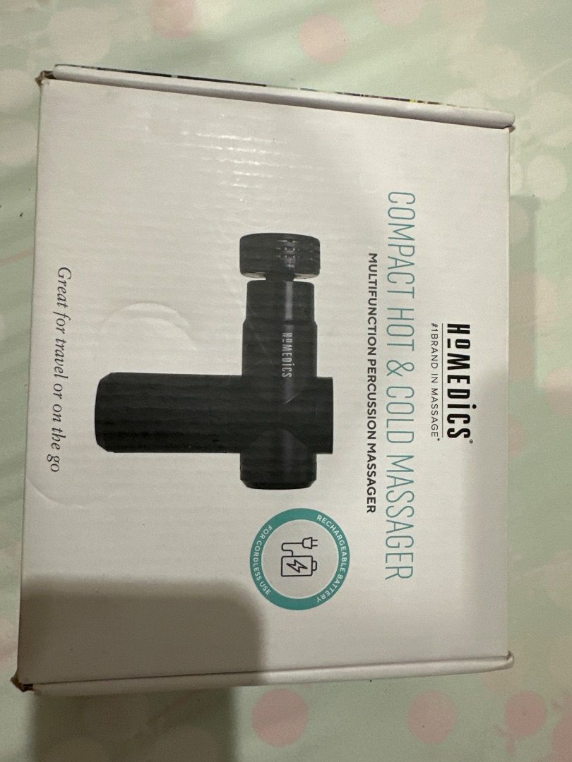 HoMedics Percussion Massage Gun (Category: Massage Devices) located in San Pedro. Submitted by shein2010 (Listing ID 1407859828, Image 2). Description: HoMedics massage gun comes with multiple attachments for targeted muscle relief. The attachments include a round head, a bullet head, and a flat head. The massage gun itself has a textured grip and the HoMedics logo is visible..