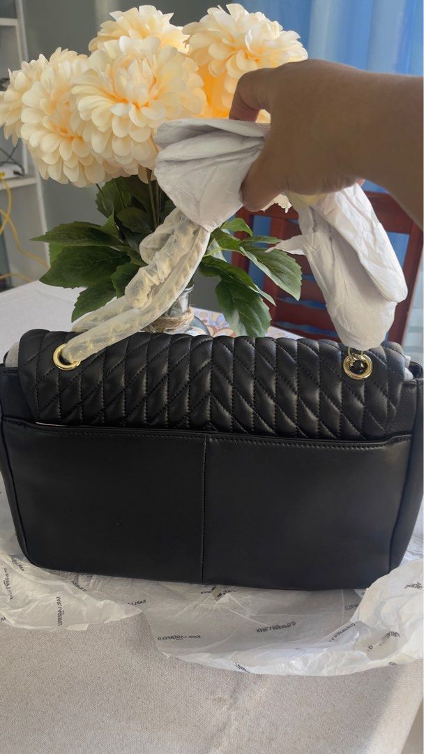 Karl Lagerfeld Paris Quilted Shoulder Bag (Category: Shoulder Bags) located in Bulacan. Submitted by rainedrops_shoppe (Listing ID 1407793980, Image 2). Description: Black Karl Lagerfeld Paris shoulder bag with a quilted design. Features a gold-tone chain strap and a turn-lock closure. The interior has a houndstooth pattern. Comes with a dust bag and original tags. Includes original packaging..
