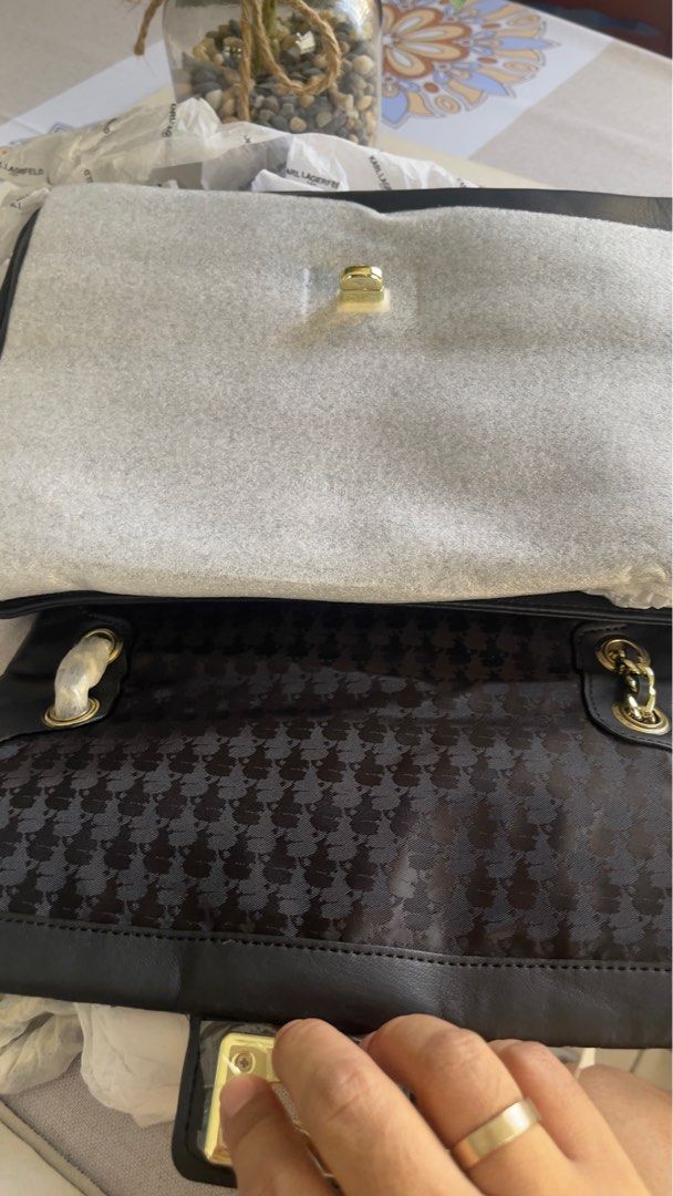 Karl Lagerfeld Paris Quilted Shoulder Bag (Category: Shoulder Bags) located in Bulacan. Submitted by rainedrops_shoppe (Listing ID 1407793980, Image 3). Description: Black Karl Lagerfeld Paris shoulder bag with a quilted design. Features a gold-tone chain strap and a turn-lock closure. The interior has a houndstooth pattern. Comes with a dust bag and original tags. Includes original packaging..