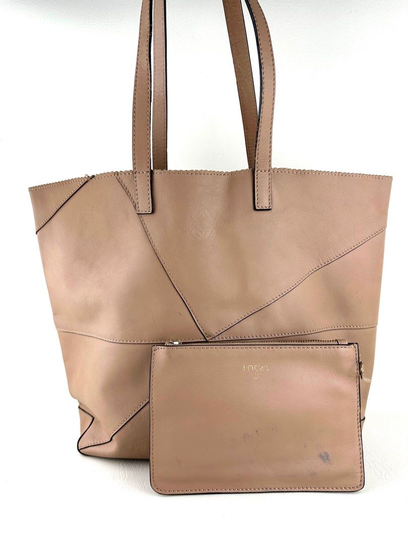 LOEWE Anagram Puzzle Tote Bag (Category: Luxury Bags & Wallets) located in Manila. Submitted by luvluxe.mnl (Listing ID 1407907818, Image 1). Description: Vintage Piece! Rare find With signs of use but still in good condition for a vintage piece Still nice & presentable!!; No functionality issue Medium to semi Large size— can fit a lot Color is so nice!! Missing pouch strap & zipper puller; please see posted pictures What you see is what you get 