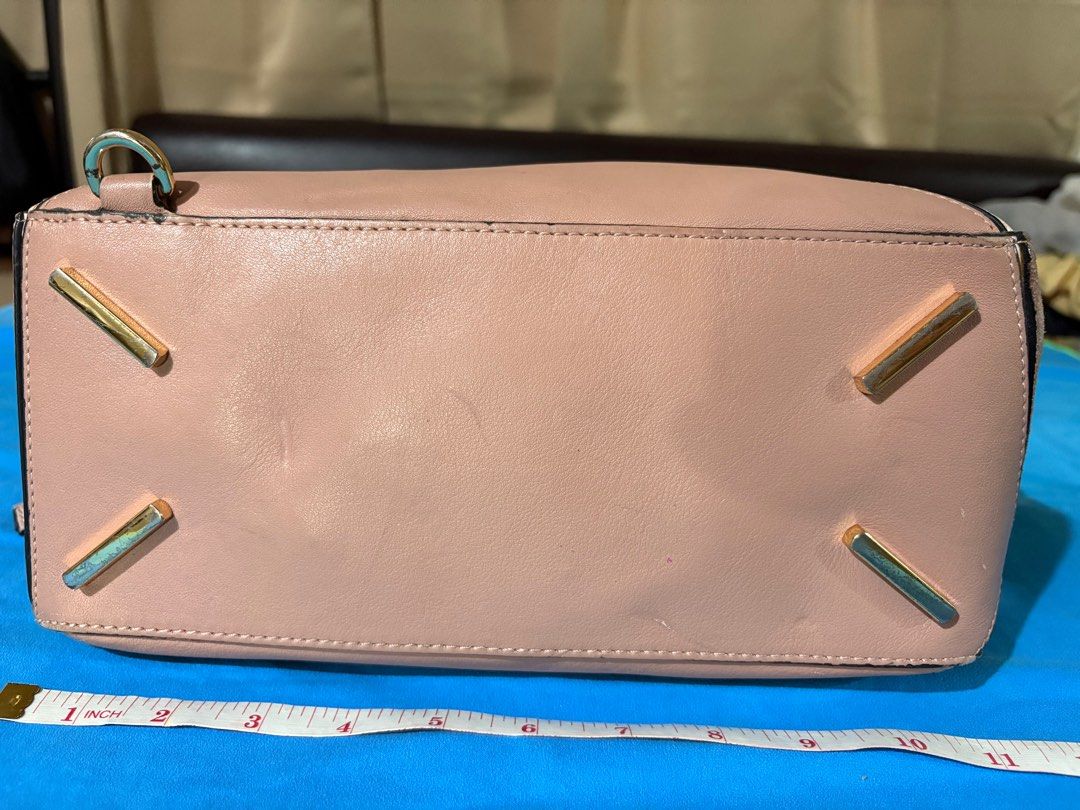 Loewe Puzzle Handbag (Category: Luxury Bags & Wallets) located in Manila. Submitted by truedeclutter (Listing ID 1407836617, Image 3). Description: - Loewe Puzzle handbag - Stunning pink color - Unique geometric design - Crafted from leather and suede - Includes top handle and detachable shoulder strap - Interior features a zipped pocket and fabric lining - Made in Spain - dirt on the inside of the bag.