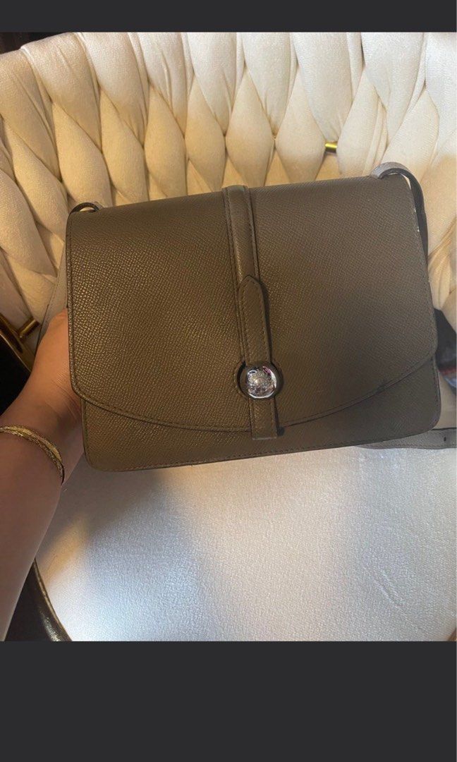 Moynat Madeleine Shoulder Bag (Category: Luxury Bags & Wallets) located in Roxas City. Submitted by lynngreyartillero (Listing ID 1407877139, Image 1). Description: - Moynat Madeleine shoulder bag - Flap closure with silver-tone clasp - Comfortable shoulder strap - Spacious interior - Exterior: Textured, muted green leather - Interior: Light grey lining - Condition: Good.