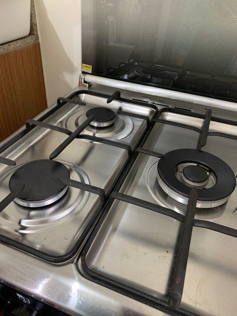 Tecnogas Oven with 3-Burner Gas Range (Category: Cookers) located in Pasay City. Submitted by jnjnin (Listing ID 1407887661, Image 3). Description: Tecnogas oven bought for around ₱25,000. Gas oven used only THREE TIMES. Cleaned and no damages. Still comes with the manual. RFS: Moving to a small condo unit where no gas cooking is allowed. - Tecnogas 3-burner gas range - Stainless steel cooktop - Black oven door with handle - Includes control knob