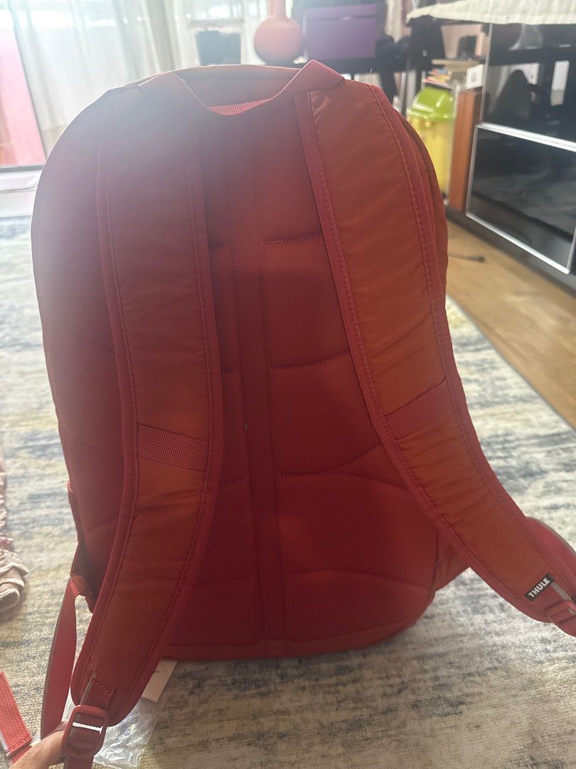 Thule Backpack (Category: Backpacks) located in Gombak. Submitted by sharking86 (Listing ID 1407760838, Image 3). Description: - Vibrant orange Thule backpack - Multiple compartments for storage - Padded back for comfort - Adjustable straps for a custom fit - Includes Thule tag - Stylish and practical design.