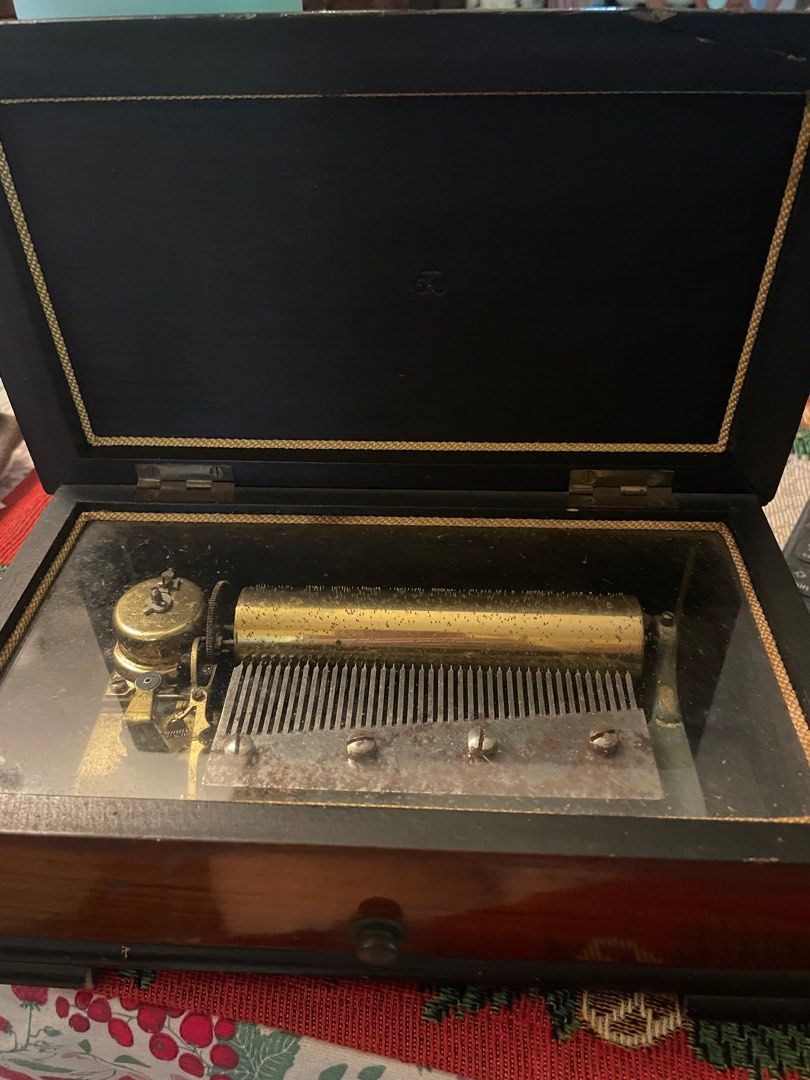 Vintage Swiss Music Box (Category: Vintage Collectibles) located in Quezon City. Submitted by deadmit (Listing ID 1407775896, Image 1). Description: - Vintage music box - Wooden box with decorative inlay - Glass window showcasing the music mechanism - Features a winding key - Marked "Made in Switzerland" and "Fabrique en Suisse" BEAUTIFUL SOUND… Swiss mechanism.