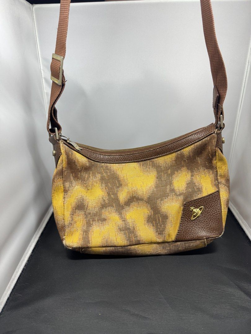 Vivienne Westwood Shoulder Bag (Category: Luxury Bags & Wallets) located in Quezon City. Submitted by edrickcu (Listing ID 1407928680, Image 1). Description: -Vivianne westwood pattern shoulder bag -Condition 8/10 -See picture the back has small leather damage -Bought for 40k - with free Tartan argylorb zip wallet - Bag & wallet only no more dustbag and box. .