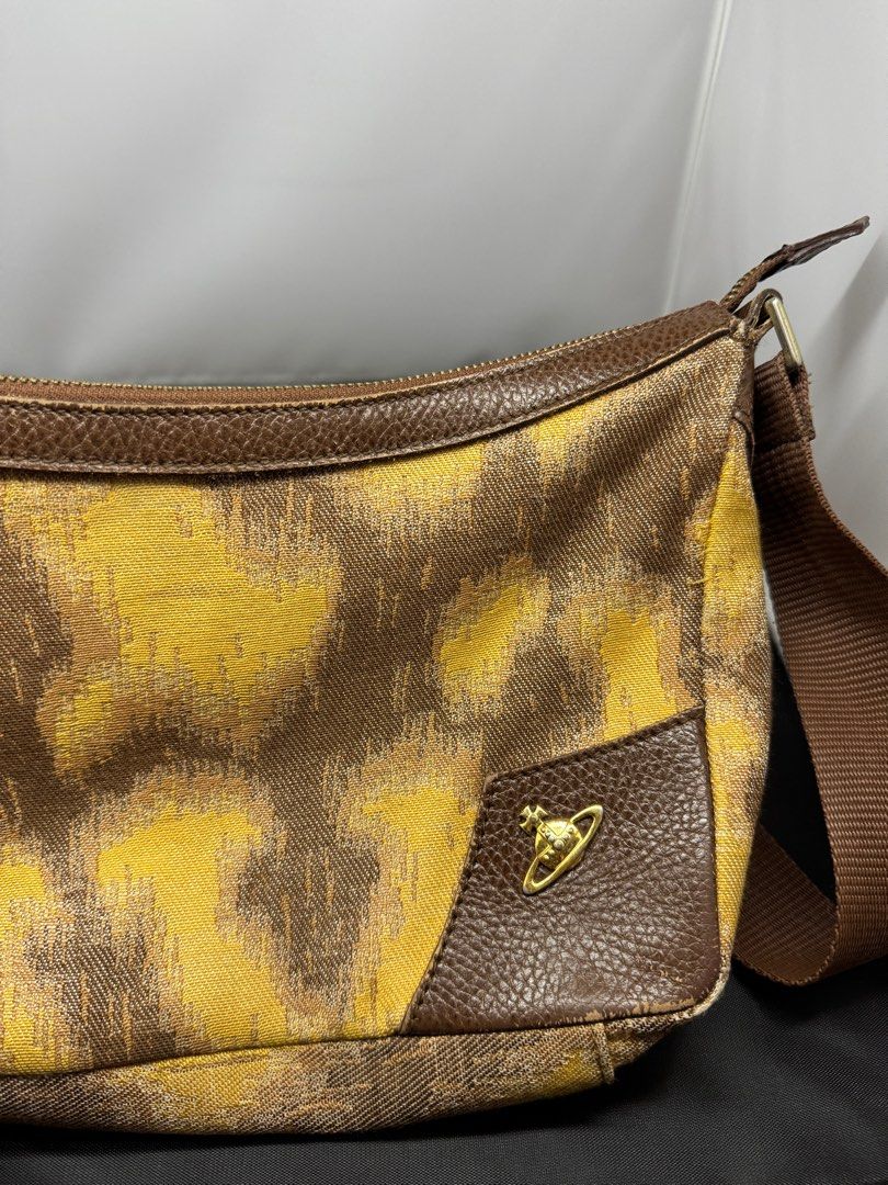 Vivienne Westwood Shoulder Bag (Category: Luxury Bags & Wallets) located in Quezon City. Submitted by edrickcu (Listing ID 1407928680, Image 3). Description: -Vivianne westwood pattern shoulder bag -Condition 8/10 -See picture the back has small leather damage -Bought for 40k - with free Tartan argylorb zip wallet - Bag & wallet only no more dustbag and box. .