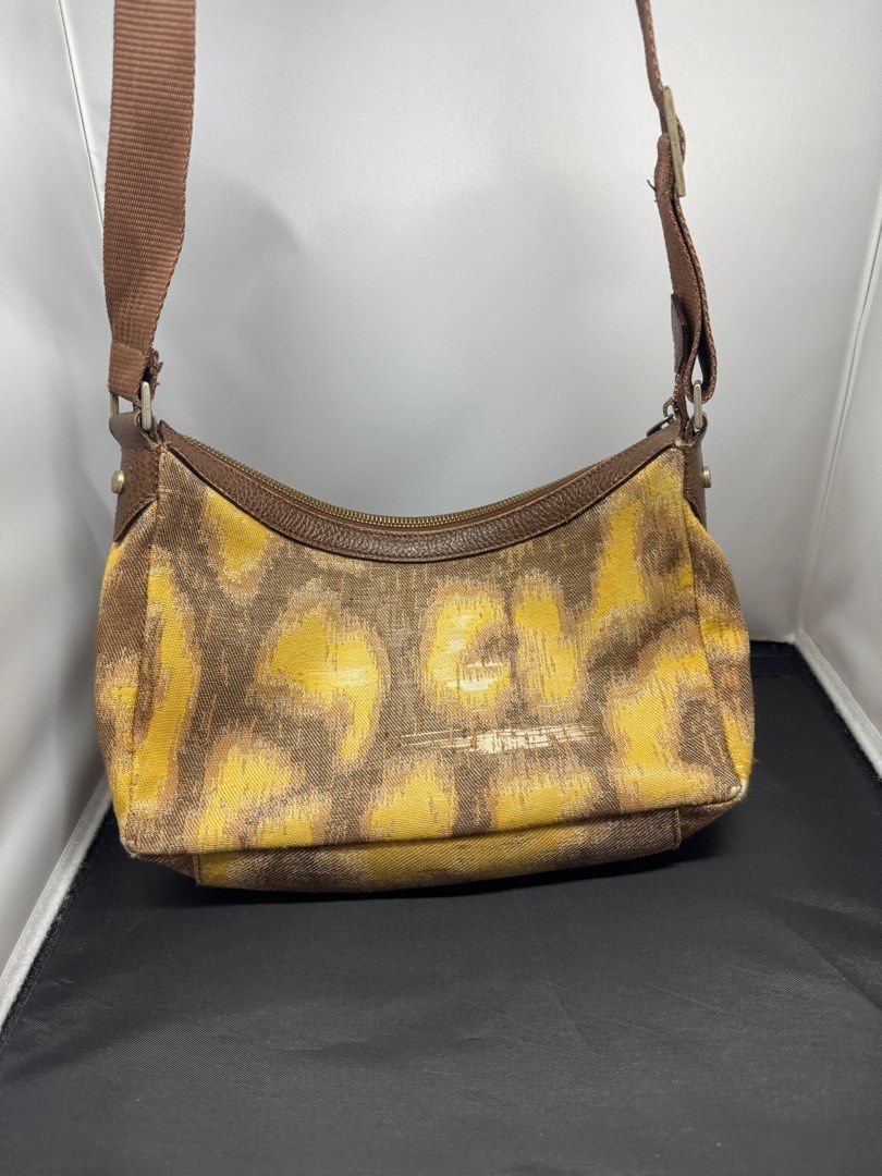 Vivienne Westwood Shoulder Bag (Category: Luxury Bags & Wallets) located in Quezon City. Submitted by edrickcu (Listing ID 1407928680, Image 2). Description: -Vivianne westwood pattern shoulder bag -Condition 8/10 -See picture the back has small leather damage -Bought for 40k - with free Tartan argylorb zip wallet - Bag & wallet only no more dustbag and box. .