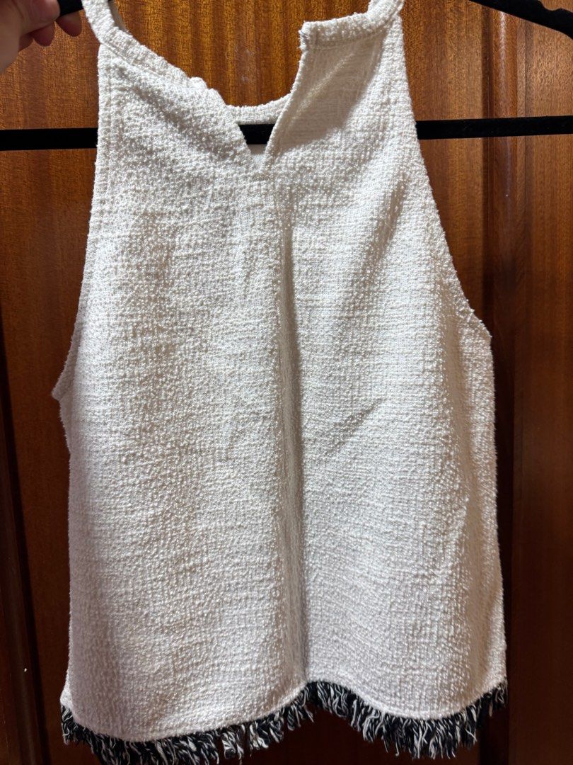 Zara Trafaluc White Textured Top (Category: Blouses) located in San Juan City. Submitted by baudeclutter (Listing ID 1407926559, Image 2). Description: White textured top from Zara Trafaluc. Features a halter neck design with a fringe detail at the hem. Made in Morocco. Size S/US M/MEX 2..