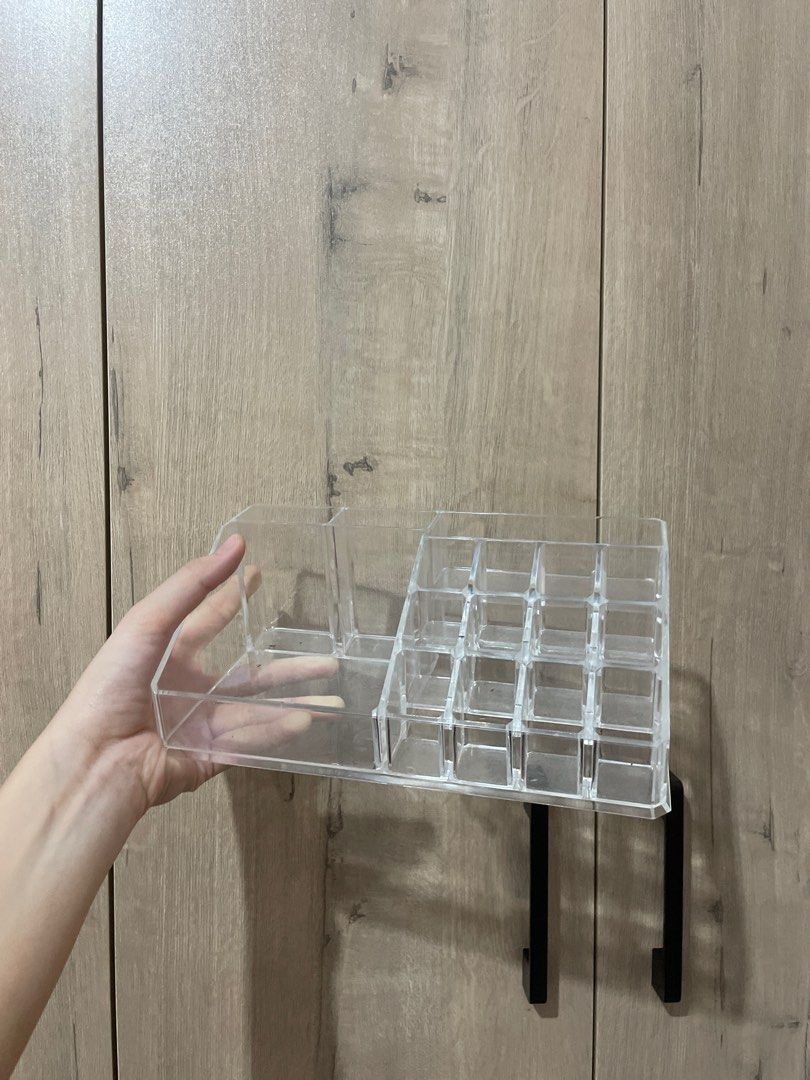 Acrylic Makeup Organizer with Lipstick Compartments (Category: Makeup) located in Naga. Submitted by robin___ (Listing ID 1408063405, Image 1). Description: - Clear acrylic makeup organizer - Multiple compartments for storage - Dedicated section for lipsticks and small items - Includes a shelf with black metal brackets - Perfect for organizing makeup essentials - Ideal for lipsticks, brushes, and other beauty items.