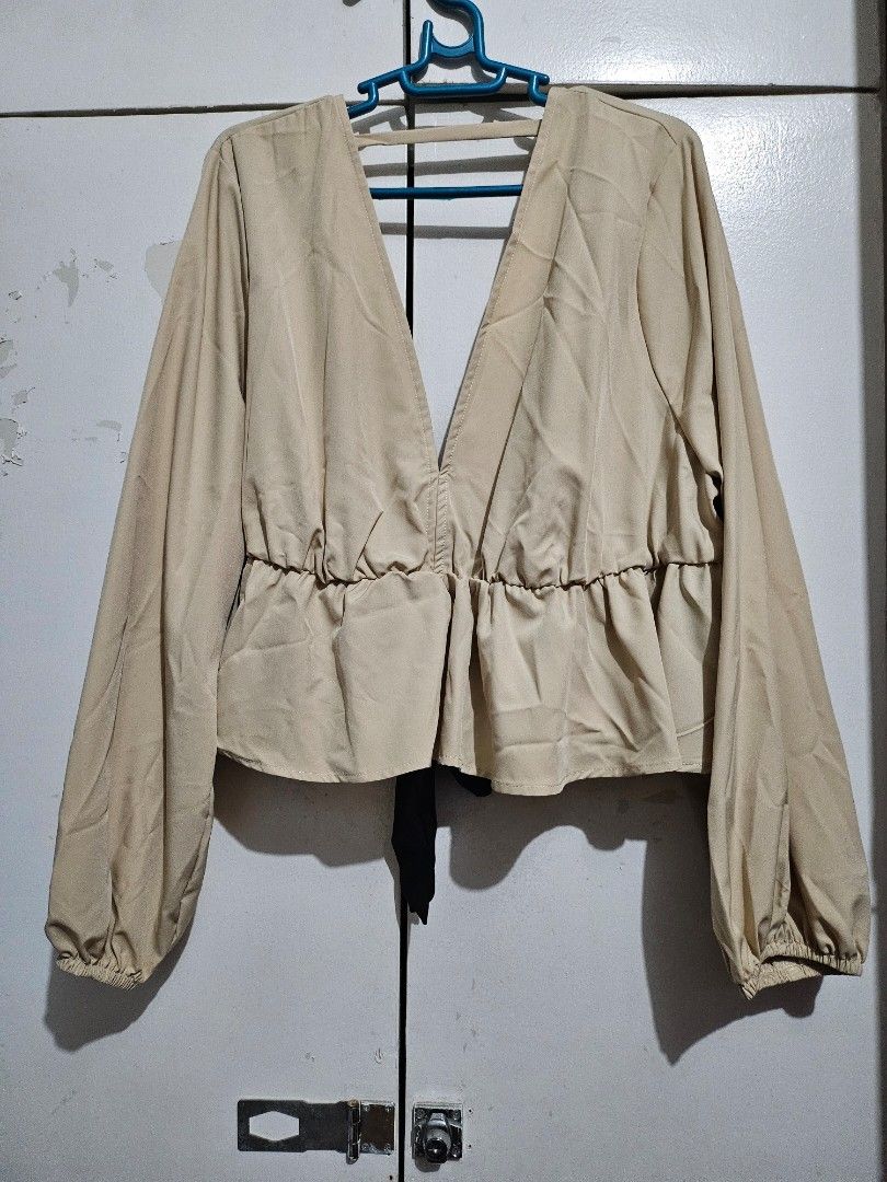 Beige Long Sleeve Top with Ruffles plus size 4x (Category: Longsleeves) located in Angeles City. Submitted by buxom.cheeks (Listing ID 1407985383, Image 2). Description: - Beige long-sleeved top - Stylish ruffled design - Black tie detail at the front - Made of smooth fabric - Versatile for various outfits.