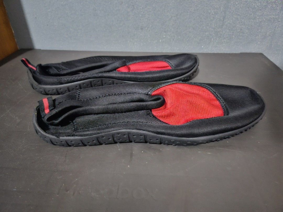 Black and Red Water Shoes size 10 (Category: Heels) located in Angeles City. Submitted by buxom.cheeks (Listing ID 1408017465, Image 2). Description: - Black water shoes with red mesh accent - Slip-on design for easy wear - Features a pull tab at the heel - Durable black rubber soles - Designed for water activities - Comfortable fit.