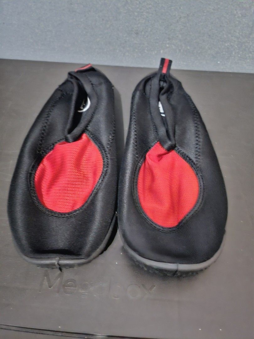 Black and Red Water Shoes size 10 (Category: Heels) located in Angeles City. Submitted by buxom.cheeks (Listing ID 1408017465, Image 1). Description: - Black water shoes with red mesh accent - Slip-on design for easy wear - Features a pull tab at the heel - Durable black rubber soles - Designed for water activities - Comfortable fit.