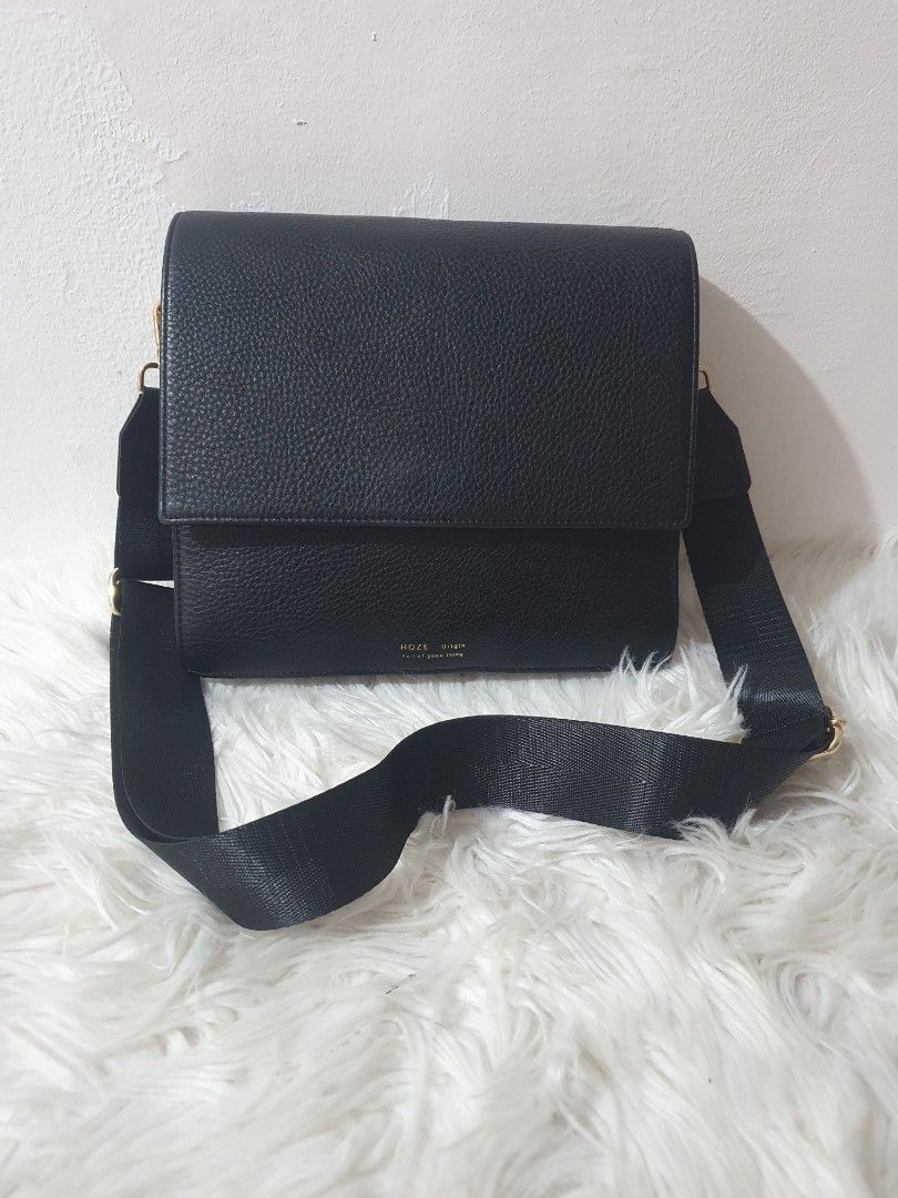 Black Crossbody Bag with Gold Hardware (Category: Sling Bags) located in Quezon City. Submitted by pongoy (Listing ID 1407959584, Image 1). Description: - Black crossbody bag - Flap closure - Adjustable black strap - Gold-colored hardware - Blue interior lining - Interior zippered pocket - Made of textured leather - Brand name visible.