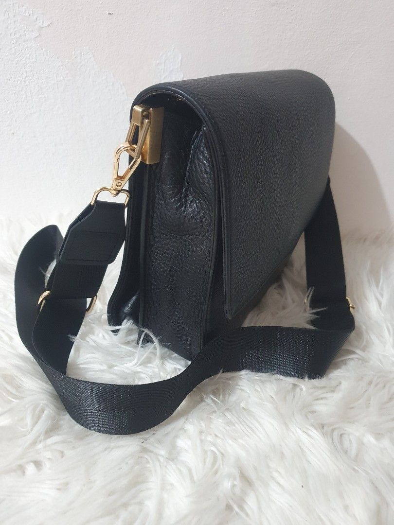 Black Crossbody Bag with Gold Hardware (Category: Sling Bags) located in Quezon City. Submitted by pongoy (Listing ID 1407959584, Image 2). Description: - Black crossbody bag - Flap closure - Adjustable black strap - Gold-colored hardware - Blue interior lining - Interior zippered pocket - Made of textured leather - Brand name visible.