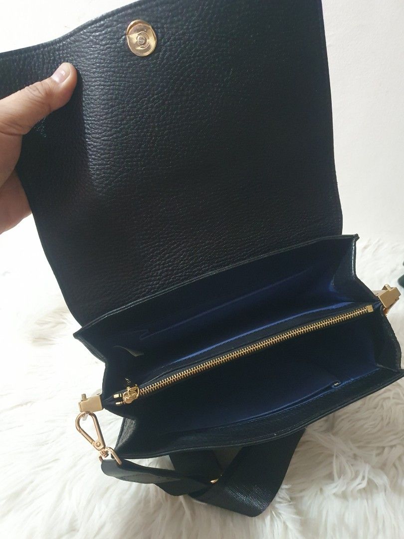 Black Crossbody Bag with Gold Hardware (Category: Sling Bags) located in Quezon City. Submitted by pongoy (Listing ID 1407959584, Image 3). Description: - Black crossbody bag - Flap closure - Adjustable black strap - Gold-colored hardware - Blue interior lining - Interior zippered pocket - Made of textured leather - Brand name visible.