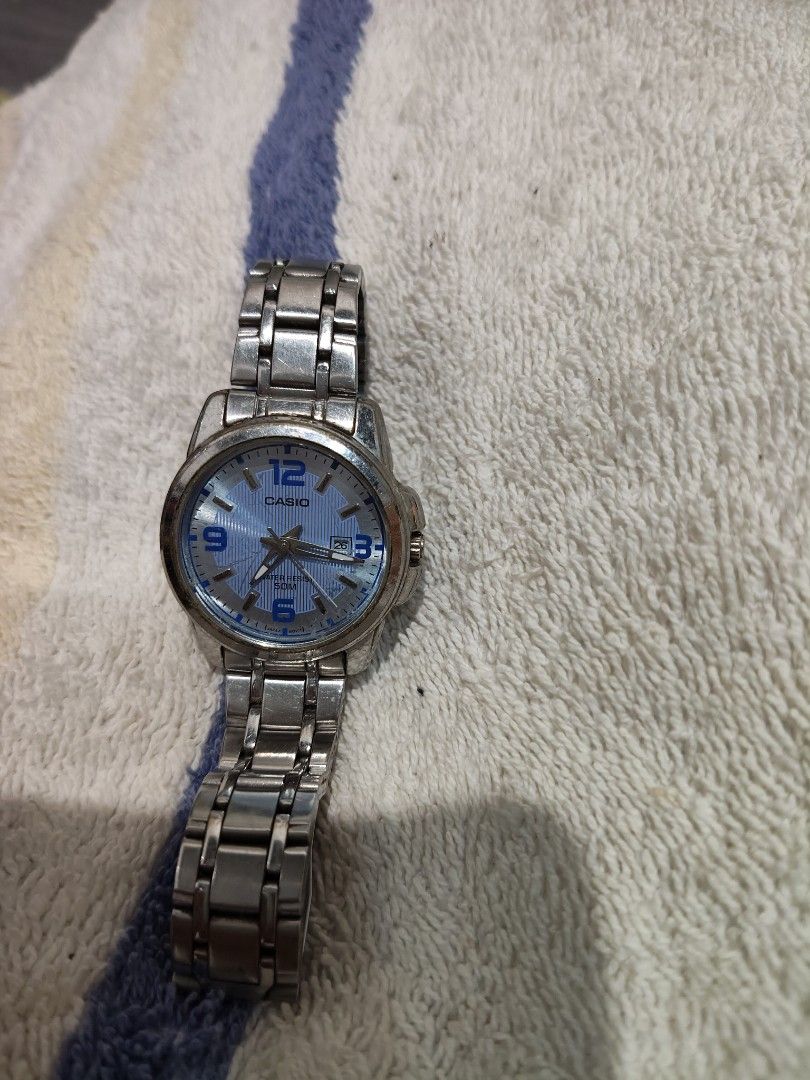 Casio Watch with Blue Dial (Category: Luxury Watches) located in Victoria. Submitted by reignf027 (Listing ID 1408047405, Image 1). Description: - Casio watch - Blue dial with silver-tone hands and markers - Stainless steel band - Date display at 3 o'clock - Classic design - Suitable for everyday wear.