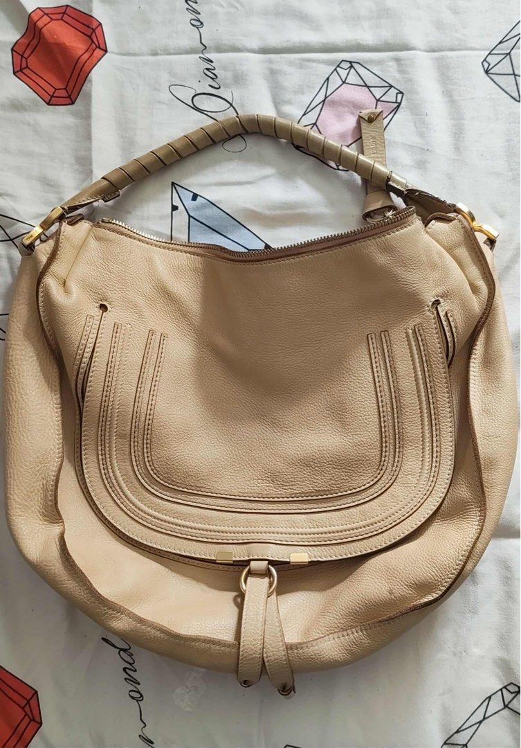 Chloe Marcie Hobo Bag (Category: Luxury Bags & Wallets) located in Quezon City. Submitted by 89misspiggy (Listing ID 1408071062, Image 1). Description: - Chloe Marcie Hobo Bag - Beige leather exterior - Curved flap design - Top handle with braided detail - Secure zip closure - Elegant gold-tone hardware - Spacious interior - Features a classic design - Stylish tassel detail on front flap.