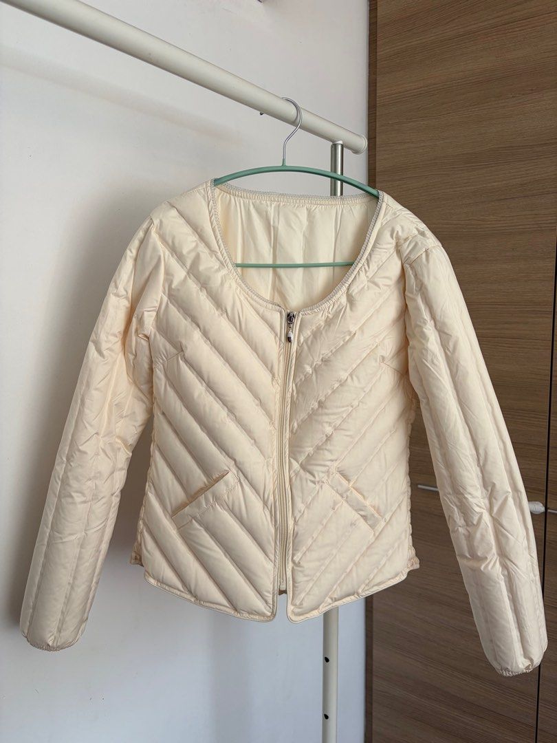 Compact down jacket (Category: Coats, Jackets and Outerwear) located in Singapore. Submitted by n_nzz (Listing ID 1407982925, Image 1). Description: - light ceam-colored compact down jacket with 68g of down feather - Zip-up front - Two pockets - never worn before but removed tag - suitable for UK size 8/10 after adding inner layer/ sweater - shoulder width 40cm, chest 92-102cm ( elastic) - Ideal for layering.
