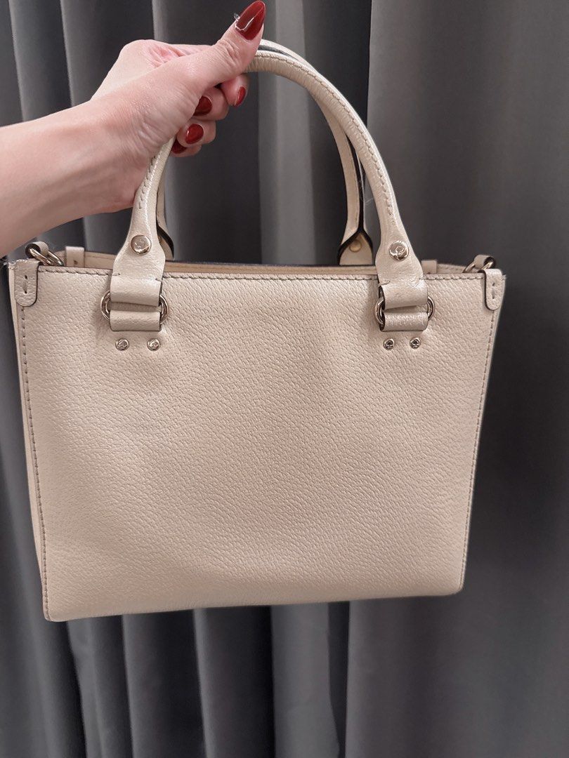 Kate Spade Wellesley Small Quinn Bag (Category: Luxury Bags & Wallets) located in Lucena. Submitted by fashioncult.ph (Listing ID 1407992149, Image 3). Description: - white Kate Spade handbag - Structured design - Dual top handles - Detachable shoulder strap - Pink fabric interior - Interior zippered pocket - Rectangular shape - Metal Kate Spade logo.