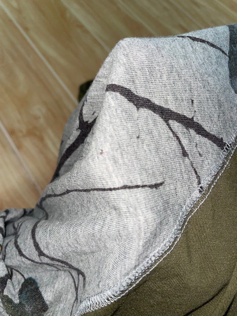 Long Sleeve Shirt with Bird Print (Category: Longsleeves) located in Manila. Submitted by ralph90755 (Listing ID 1408066801, Image 3). Description: - Long-sleeved shirt - Features a unique bird and tree branch print - Olive green sleeves - Gray body - Crew neck - Relaxed fit - Gray cuffs on sleeves - Paired with camouflage pants.