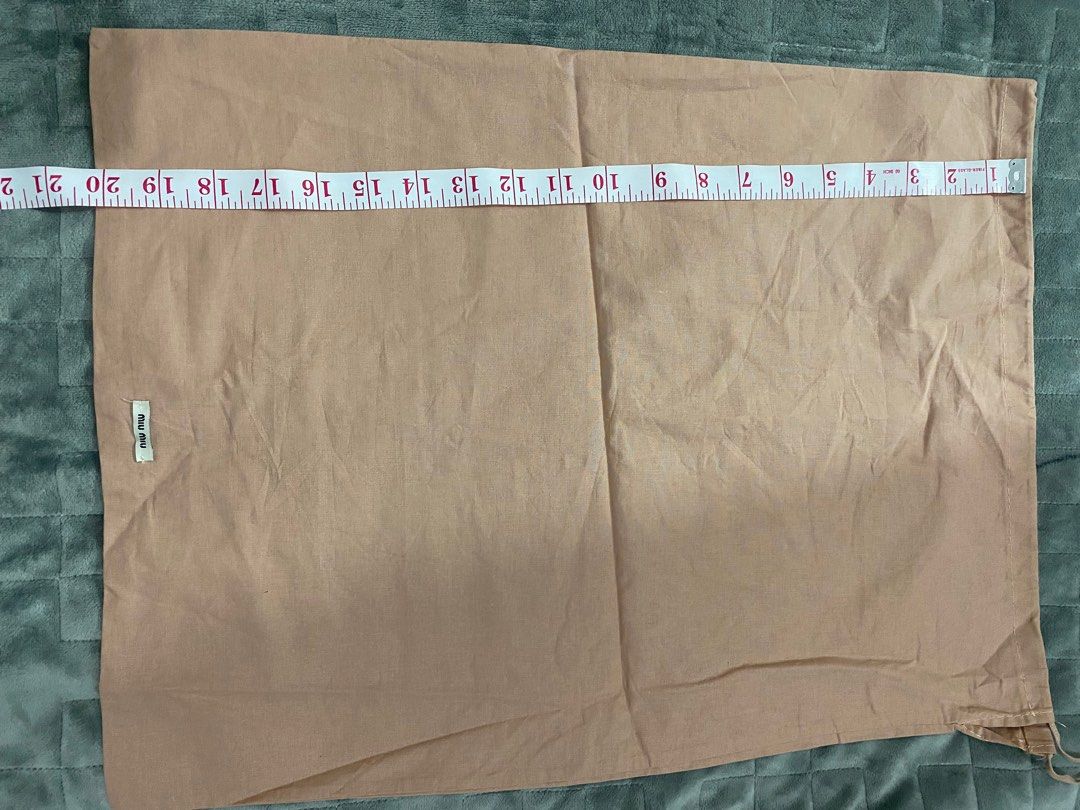 Miu Miu Dust Bag (Category: Luxury Bags & Wallets) located in Manila. Submitted by angeliemataro25 (Listing ID 1407973982, Image 3). Description: - Authentic Miu Miu dust bag - Color: Light brown - Dimensions: Approximately 14 inches (length) x 9 inches (width) - Closure: Drawstring - Features the Miu Miu logo.