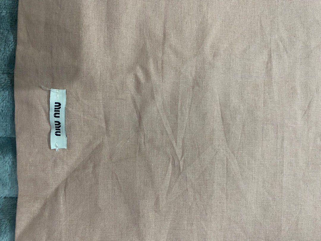 Miu Miu Dust Bag (Category: Luxury Bags & Wallets) located in Manila. Submitted by angeliemataro25 (Listing ID 1407973982, Image 2). Description: - Authentic Miu Miu dust bag - Color: Light brown - Dimensions: Approximately 14 inches (length) x 9 inches (width) - Closure: Drawstring - Features the Miu Miu logo.
