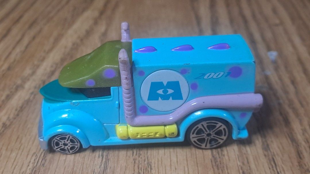 Monsters Inc. Truck Toy (Category: Vehicle & Diecast Models) located in Davao. Submitted by bravemoon_556cd5 (Listing ID 1408027955, Image 2). Description: - Monsters, Inc. themed toy truck - Diecast metal and plastic construction - Light blue body with purple polka dots - Green top - Black wheels - Features the Monsters, Inc. logo - Includes the number "2001".
