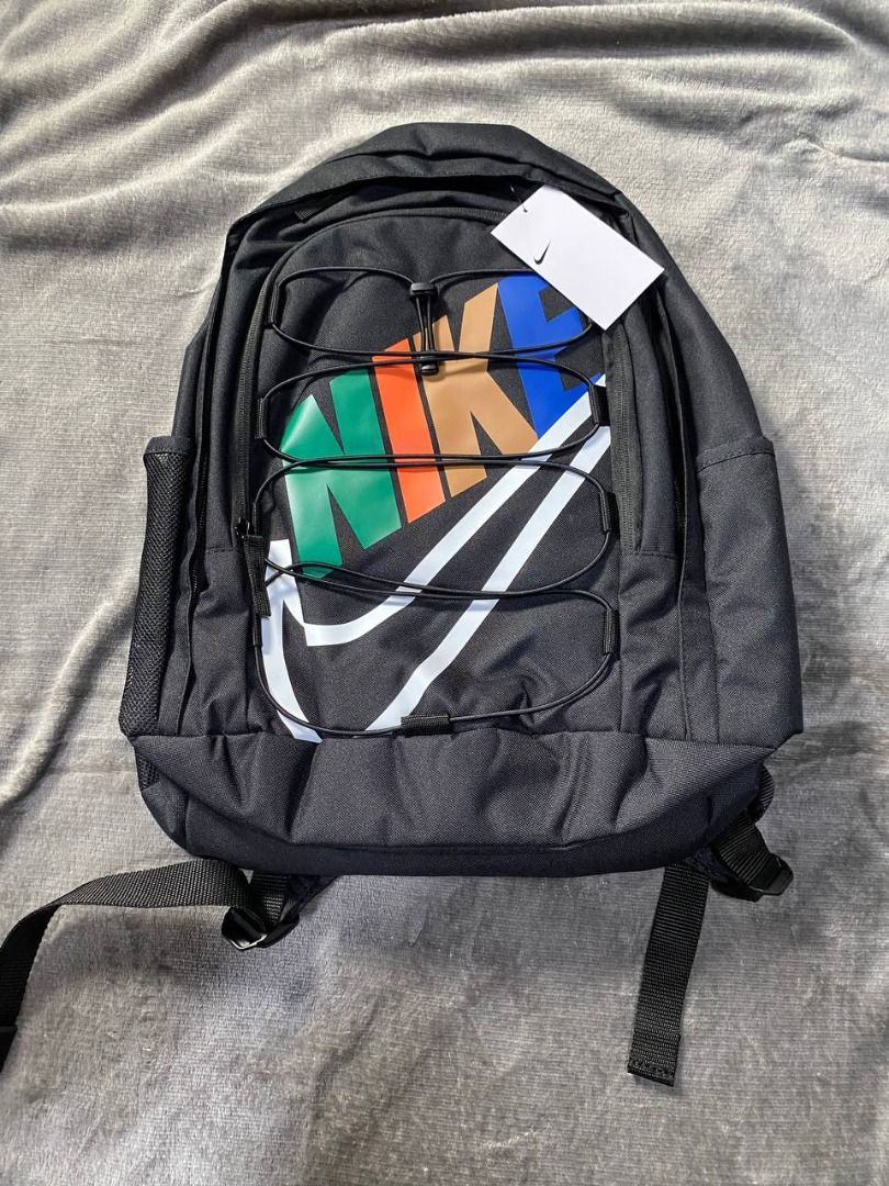 Brand New Nike Hayward Backpack 26L (Category: Backpacks) located in Valenzuela. Submitted by emg.everythingmustgo (Listing ID 1408077527, Image 1). Description: - Nike backpack with a large white logo and colorful design. - Main compartment for storage. - Front and side pockets for extra space. - Adjustable straps for a comfortable fit. - Includes a small logo on the back. - Comes with a tag attached. Original SRP 3,295.