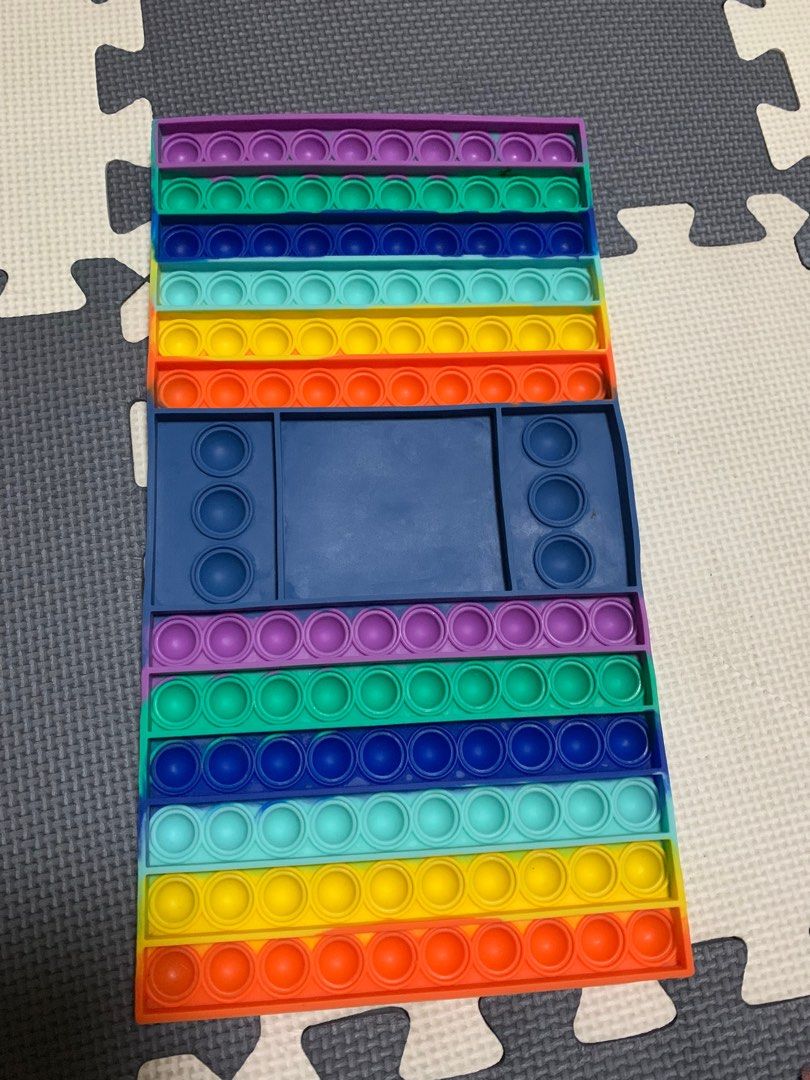 Rainbow Pop It Fidget Toy (Category: Educational & Learning Toys) located in Cavite. Submitted by rwyanewade39874 (Listing ID 1407942209, Image 1). Description: - Large, rectangular rainbow Pop It fidget toy. - Features multiple rows of colorful bubbles. - Includes a blue section with additional bubble features. - Designed for sensory play and stress relief. - Fun and engaging for kids and adults..