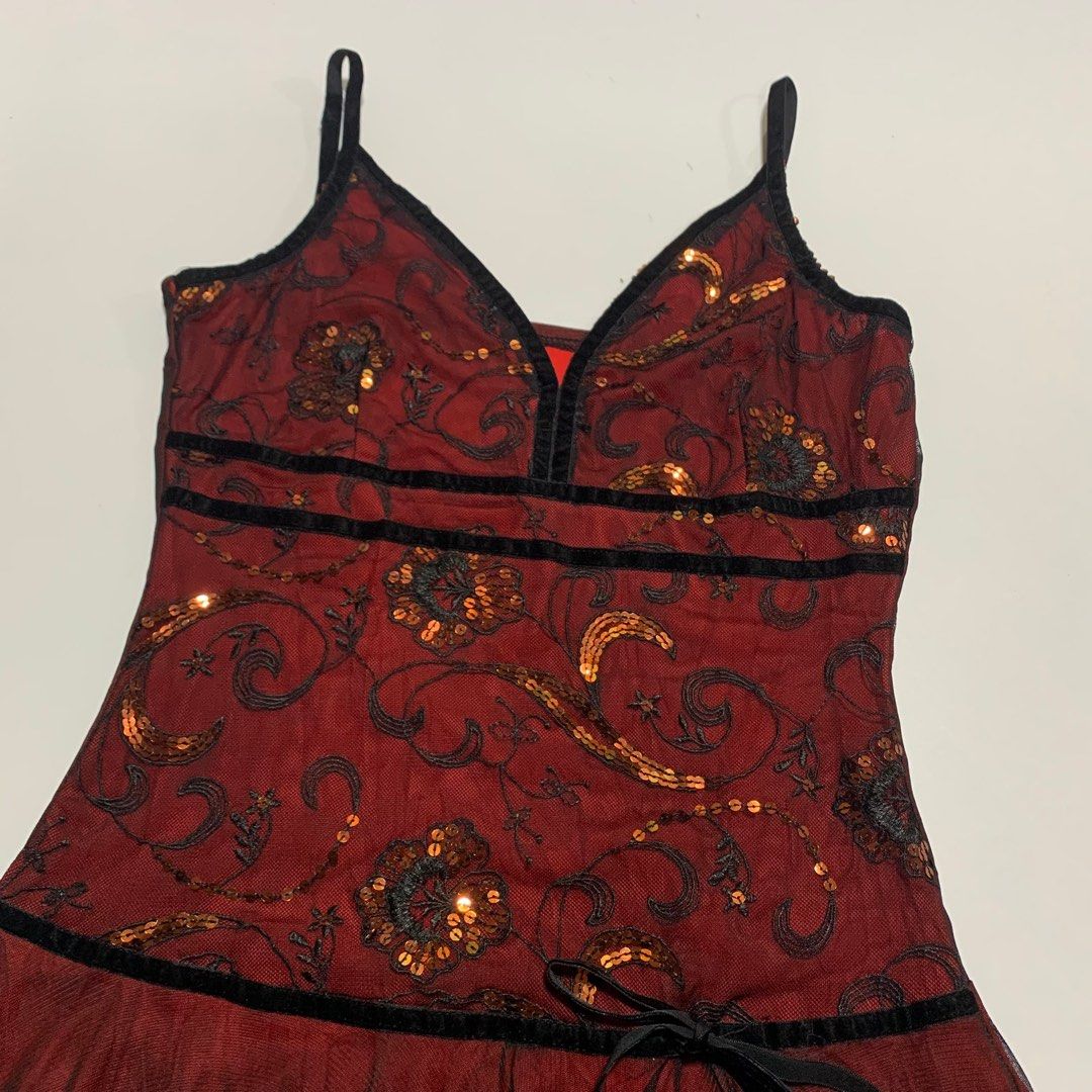 Red and Black Spaghetti Strap Dress (Category: Dresses) located in Bacoor. Submitted by yumeruwu (Listing ID 1408042461, Image 2). Description: - Elegant spaghetti strap dress - Red and black color scheme - V-neckline - Embellished bodice with sequins - Fitted waist - Layered skirt with black tulle overlay and lace trim - Includes a black ribbon tie - Perfect for special occasions.