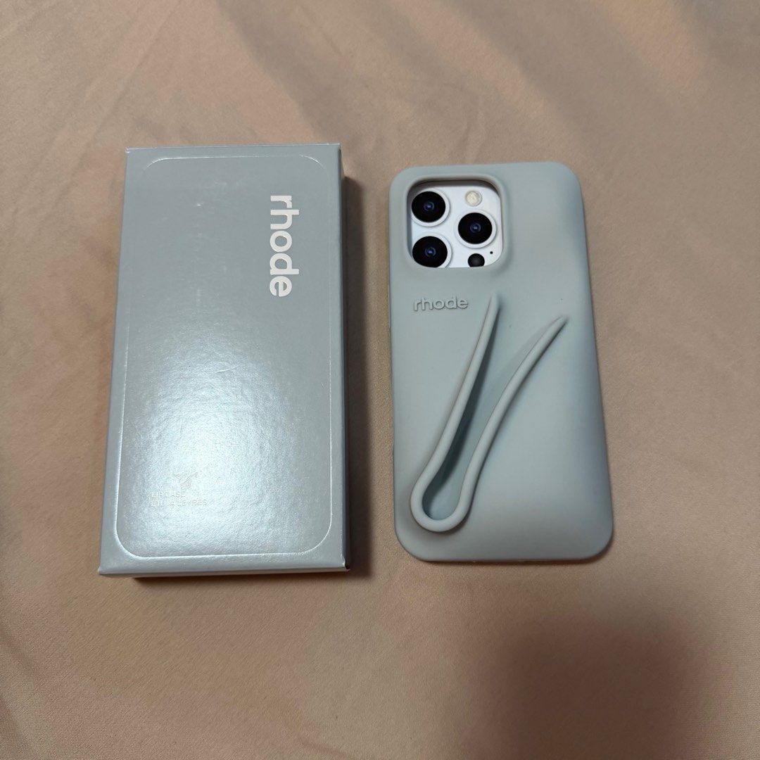 Rhode Lip Case 16pro (Category: Cases & Sleeves) located in Marikina City. Submitted by sushmitamayc (Listing ID 1407972594, Image 1). Description: - Rhode Lip Case for iPhone 16 Pro - Stylish light blue-gray color - Features a unique lip design for enhanced grip - Comes with the original box.