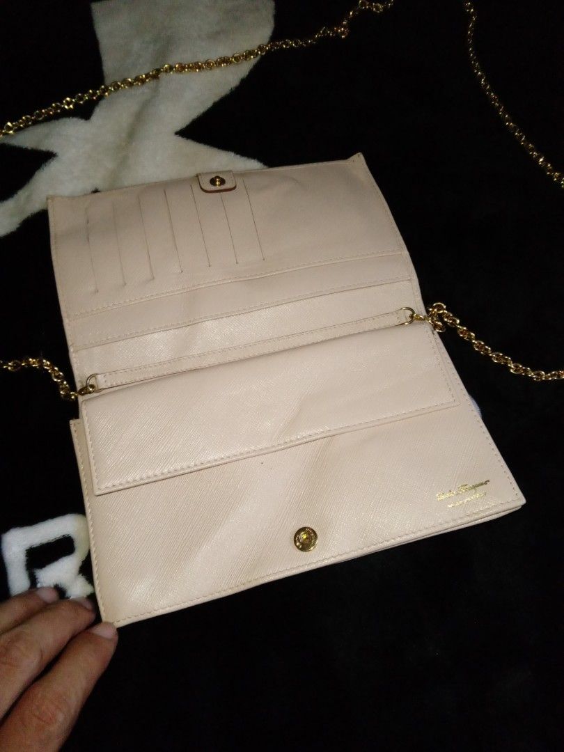 Salvatore Ferragamo Chain Bag (Category: Luxury Bags & Wallets) located in Manila. Submitted by bethlehema07352 (Listing ID 1407977937, Image 2). Description: - Salvatore Ferragamo Chain Bag - Color: Light Beige - Bow detail - Gold chain strap - Flap closure - Interior with card compartments - Made in Italy - Model: AB-22B600 - Dimensions: Approx. 4.5" x 7.5".