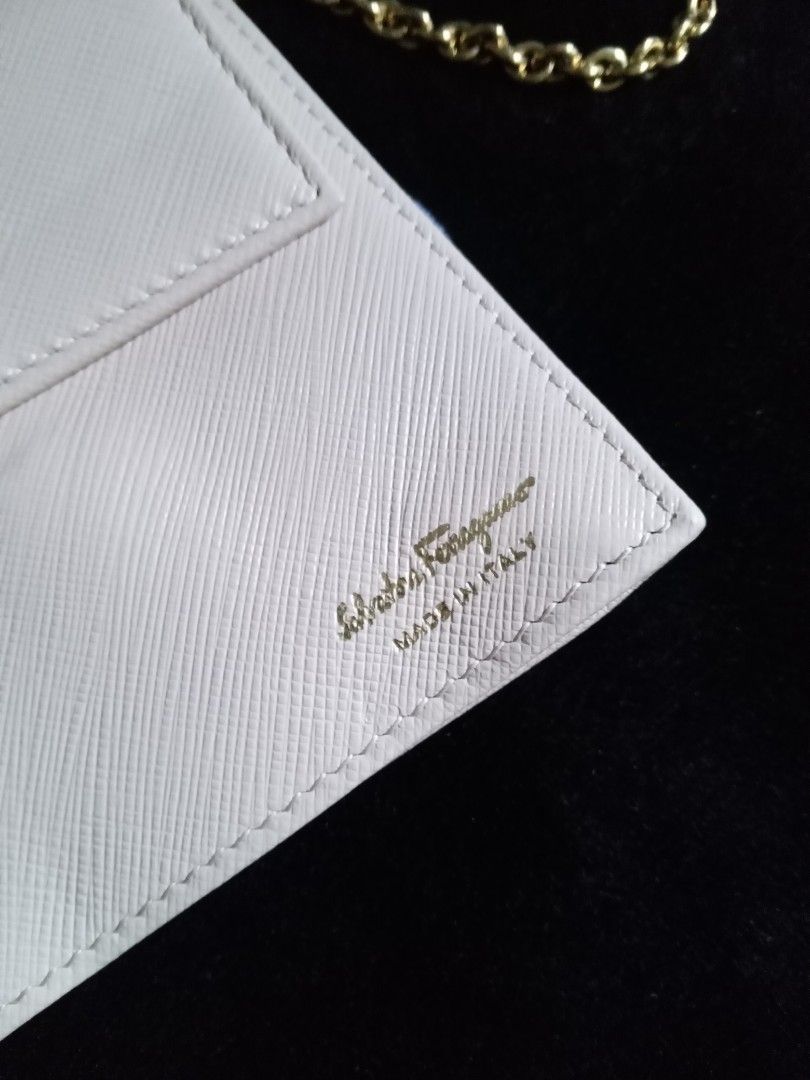 Salvatore Ferragamo Chain Bag (Category: Luxury Bags & Wallets) located in Manila. Submitted by bethlehema07352 (Listing ID 1407977937, Image 3). Description: - Salvatore Ferragamo Chain Bag - Color: Light Beige - Bow detail - Gold chain strap - Flap closure - Interior with card compartments - Made in Italy - Model: AB-22B600 - Dimensions: Approx. 4.5" x 7.5".