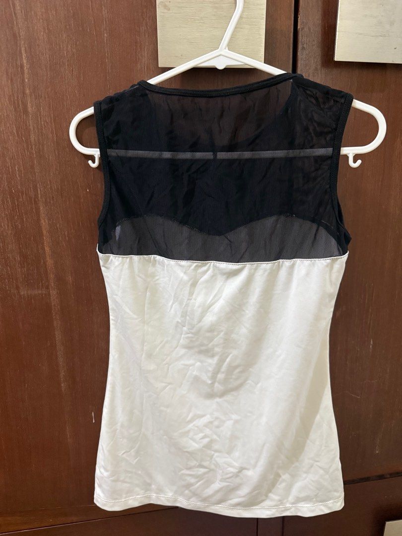 Sleeveless Top with Mesh Detail (Category: Sleeveless) located in Quezon City. Submitted by _cmls (Listing ID 1408077605, Image 2). Description: - Sleeveless top - Features a black mesh panel at the top and back - White body - Scoop neckline - Fitted silhouette - Made of lightweight material - Ideal for warm weather.