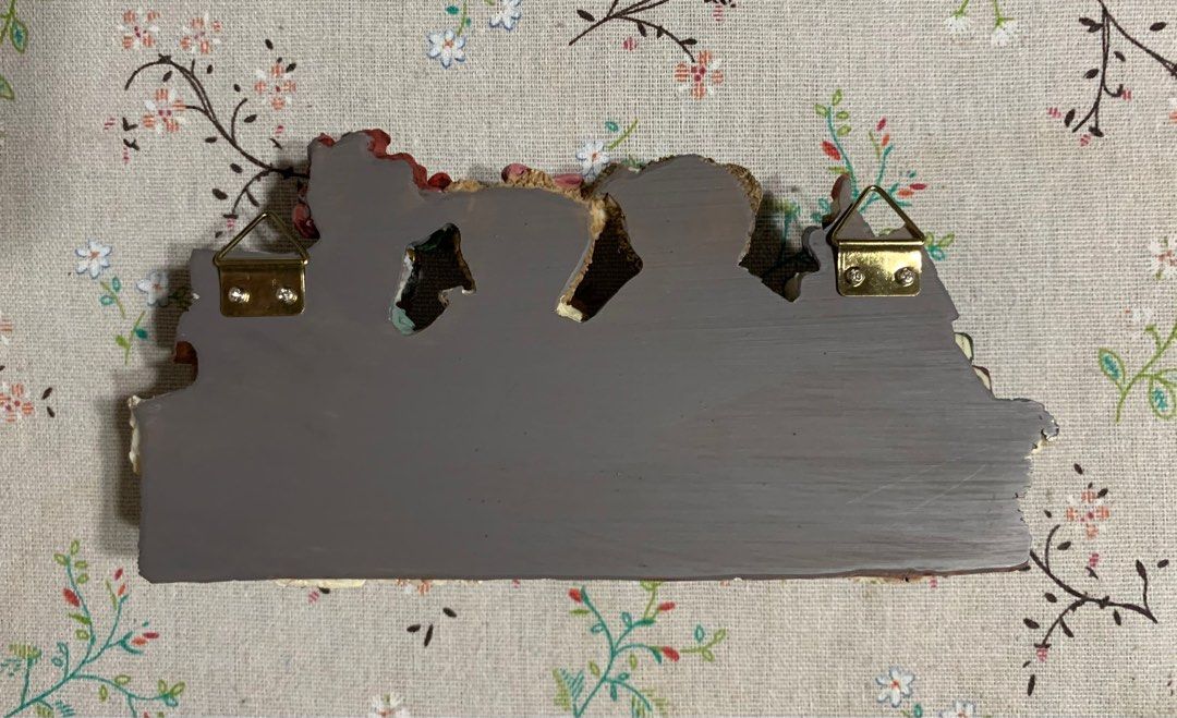 Unique Collection Bear Family Wall Decor (Category: Wall Decor) located in San Mateo. Submitted by kusinaninanan (Listing ID 1408063079, Image 2). Description: Charming wall decor features a bear family scene with books and flowers. It has three hooks for hanging items. The back has two metal hangers for easy mounting. It comes in its original box. The item is a decorative piece, perfect for adding a touch of whimsy to any room..