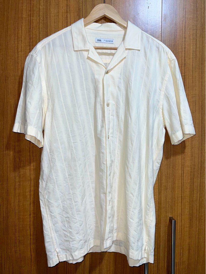 Zara Short Sleeve Shirt (Category: Tshirts & Polo Shirts ) located in Manila. Submitted by drreeves (Listing ID 1408030281, Image 1). Description: - Zara cream shirt - Short sleeves - Camp collar - Vertical stripe pattern - Button-down - Relaxed fit - Worn only twice. Bought for 2700 pesos - Negotiable.