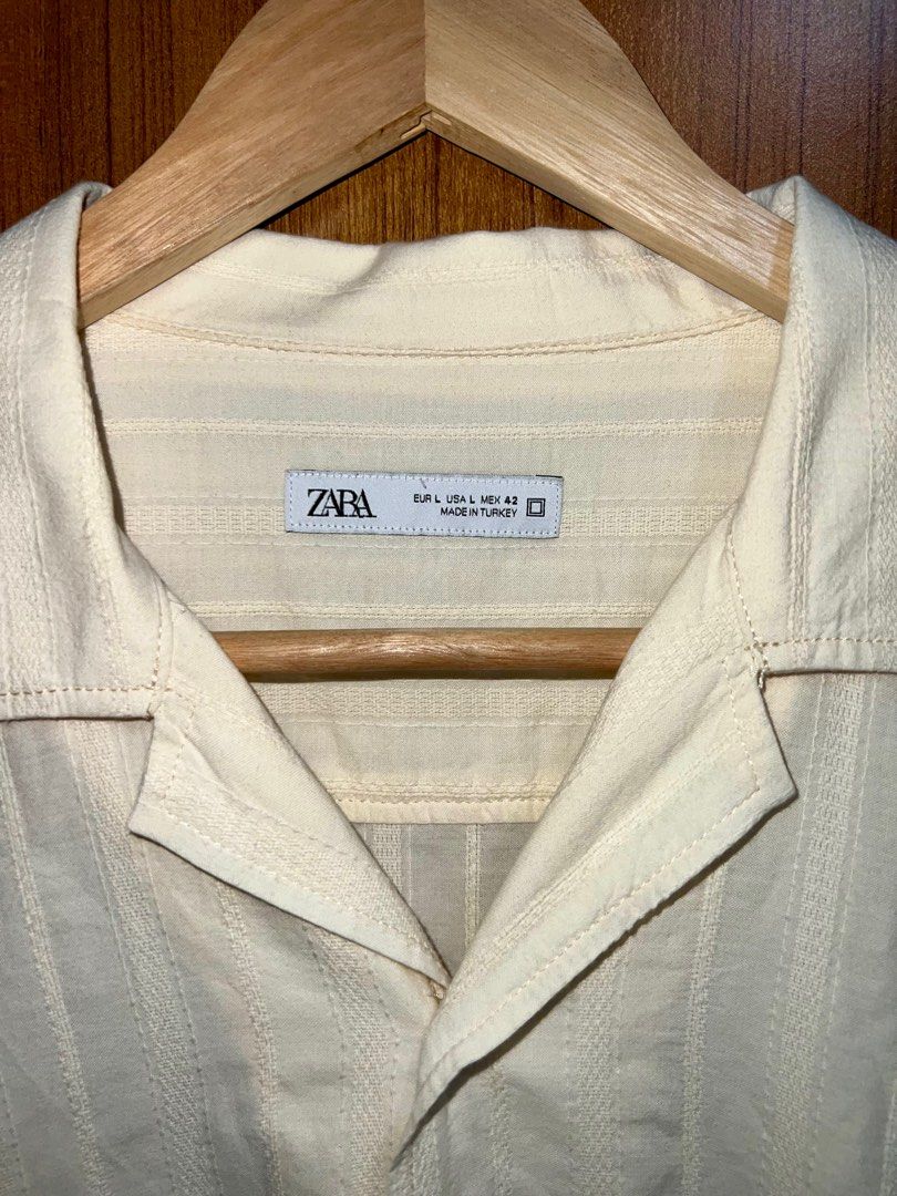 Zara Short Sleeve Shirt (Category: Tshirts & Polo Shirts ) located in Manila. Submitted by drreeves (Listing ID 1408030281, Image 2). Description: - Zara cream shirt - Short sleeves - Camp collar - Vertical stripe pattern - Button-down - Relaxed fit - Worn only twice. Bought for 2700 pesos - Negotiable.