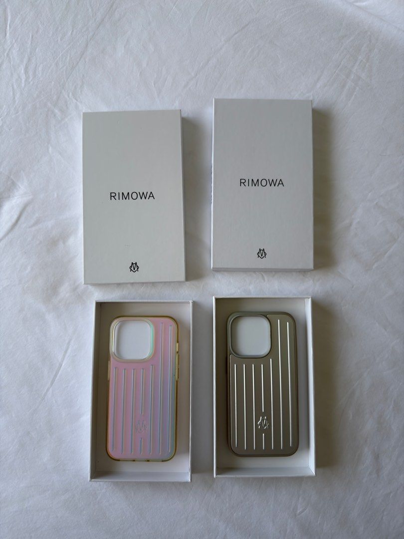Authentic Rimowa iPhone case (15 Pro & 14 Pro) (Category: Cases & Sleeves) located in Cebu City. Submitted by pnewman87 (Listing ID 1408125391, Image 1). Description: Rimowa iridescent polycarbonate case for iPhone 15 Pro - used but in good condition Php 3,500 - purchased in Shanghai <SOLD> Rimowa aluminum case for iPhone 14 Pro - damaged on the bumper part, but still usable and can be fixed Php 2,500 - purchased in Tokyo All authentic, with box 