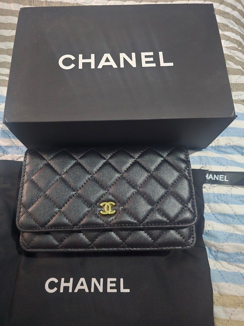 Chanel Quilted Wallet on Chain (Category: Luxury Bags & Wallets) located in Quezon City. Submitted by steph78 (Listing ID 1408145386, Image 1). Description: - Classic black quilted design - Elegant gold-tone chain strap - Features the iconic interlocking CC logo - Comes with original box and dust bag - Interior with multiple compartments and card slots - Secure magnetic snap closure - top grade quality.