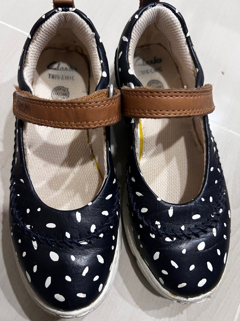 Clarks Trikenic Polka Dot Mary Jane Shoes (Category: Babies & Kids Fashion) located in Ampang. Submitted by rarahanna (Listing ID 1408196034, Image 1). Description: Clarks Trikenic Mary Jane shoes in navy blue with white polka dots. Features a brown leather strap with a velcro closure. The shoes have a white sole. The size is 11G 29W 11.5W. Made with Italian leather. Light weight shoe for walking..
