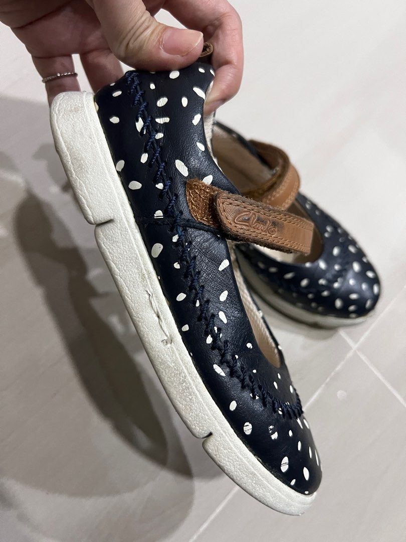 Clarks Trikenic Polka Dot Mary Jane Shoes (Category: Babies & Kids Fashion) located in Ampang. Submitted by rarahanna (Listing ID 1408196034, Image 2). Description: Clarks Trikenic Mary Jane shoes in navy blue with white polka dots. Features a brown leather strap with a velcro closure. The shoes have a white sole. The size is 11G 29W 11.5W. Made with Italian leather. Light weight shoe for walking..