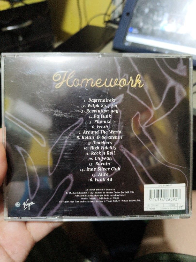 Daft Punk Homework CD (Category: CDs & DVDs) located in San Jose del Monte. Submitted by xtian.jvne (Listing ID 1408166033, Image 2). Description: Original Daft Punk "Homework" CD. Features tracks like "Da Funk", "Around the World", and "Burnin'". The CD case shows the album title and tracklist. A classic album for any electronic music fan..