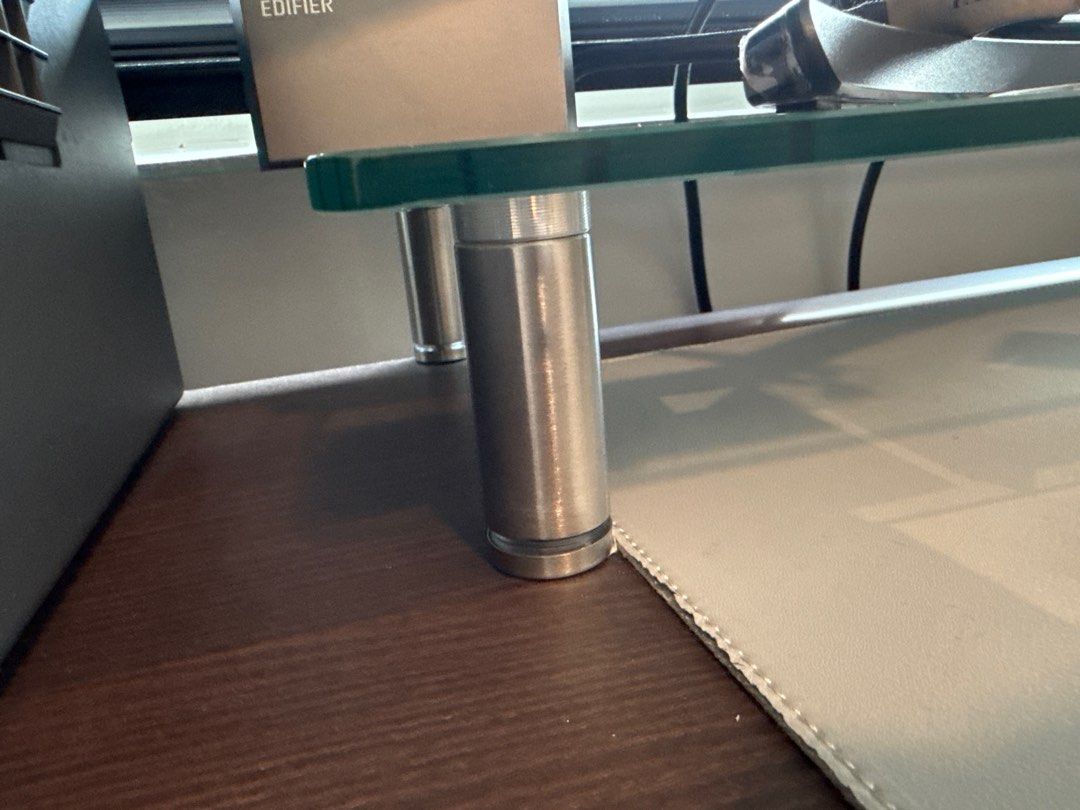 Desk Riser (Category: Home Improvement Tools & Accessories) located in Singapore. Submitted by poodeepop (Listing ID 1408198827, Image 2). Description: Glass desk riser, legs with adjustable height. Photo is representative - shows my current desk. I have a second set that is in storage that was used for less than a year..