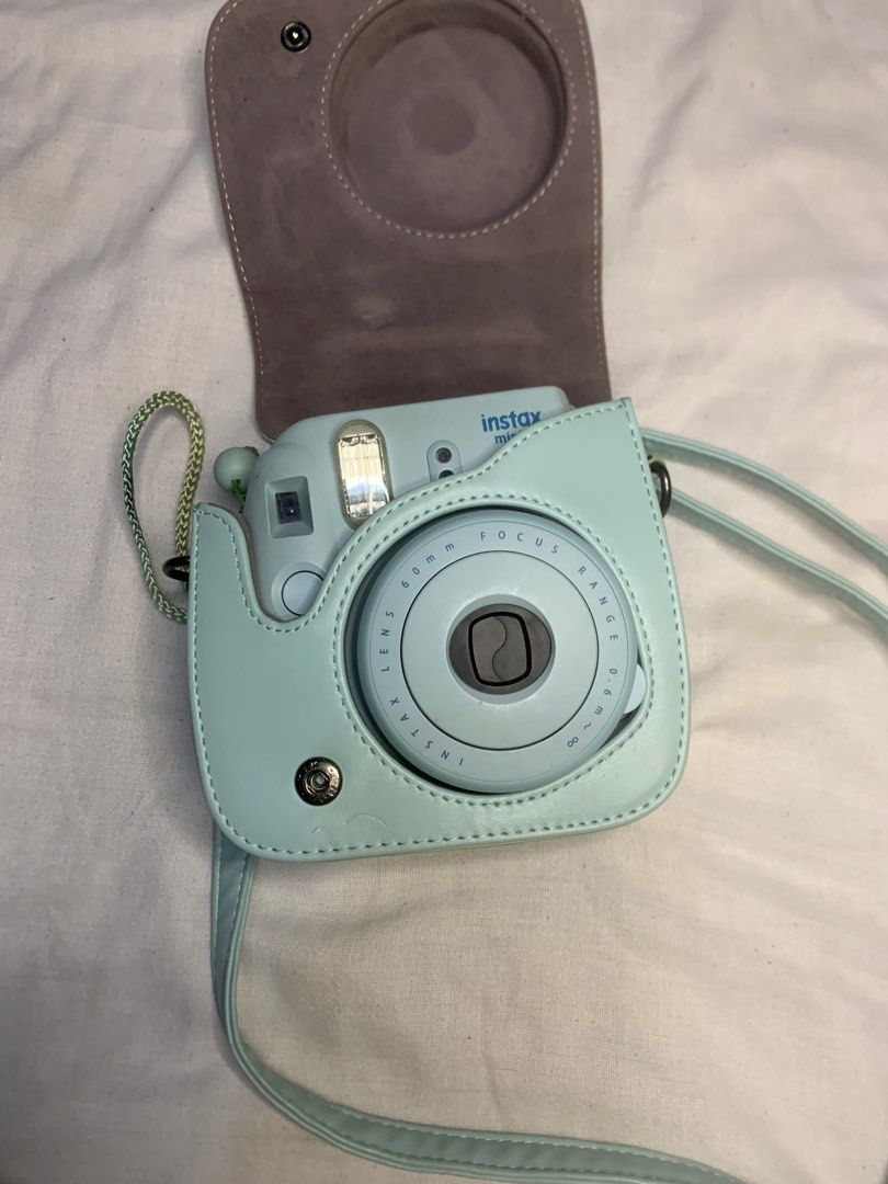 Fujifilm Instax Mini 8 Camera (Category: Cameras) located in Manila. Submitted by lustreloom (Listing ID 1408179563, Image 1). Description: - Fujifilm Instax Mini 8 instant camera - Mint green color - Includes matching camera case and strap - 60mm focus lens - Ready to capture photos.