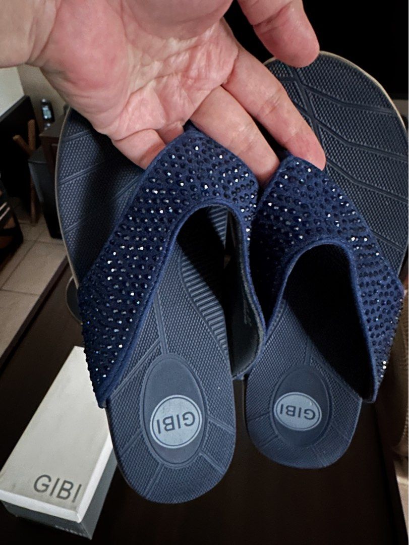 Gibi Flip-flops with Rhinestones (Category: Slippers and slides) located in Quezon City. Submitted by spatio (Listing ID 1408181202, Image 2). Description: Elegant Gibi flip-flops in navy blue. Features a strap adorned with rhinestones. The sole has a textured design for grip. Comes with the original box. Size 37. Originally bought at 1699. .